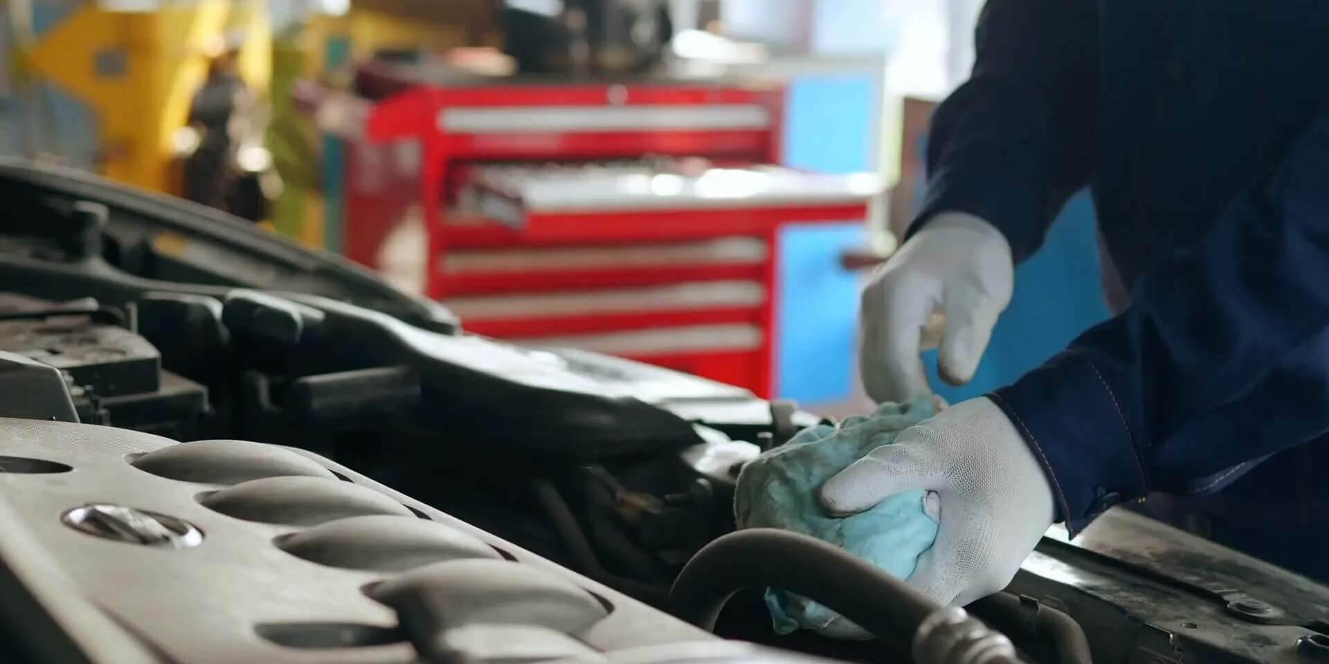 an automotive student checks the oil in a car