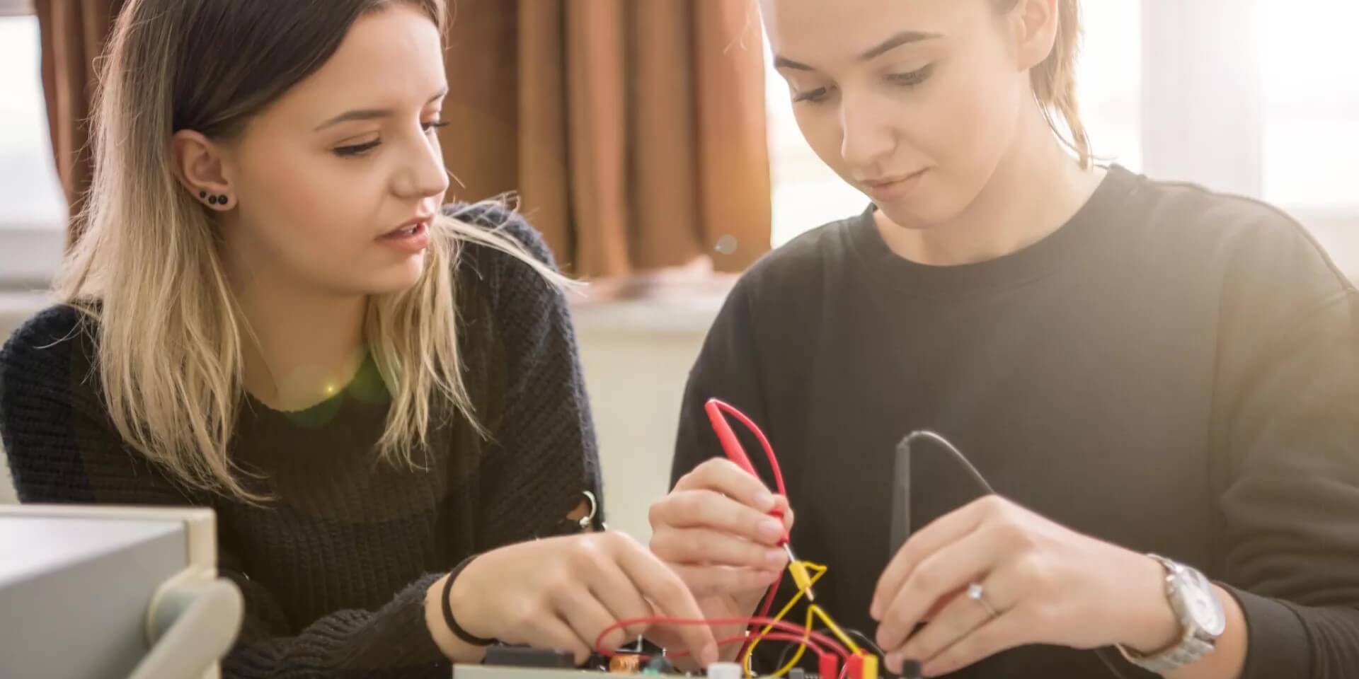 a teacher helps a student with a project