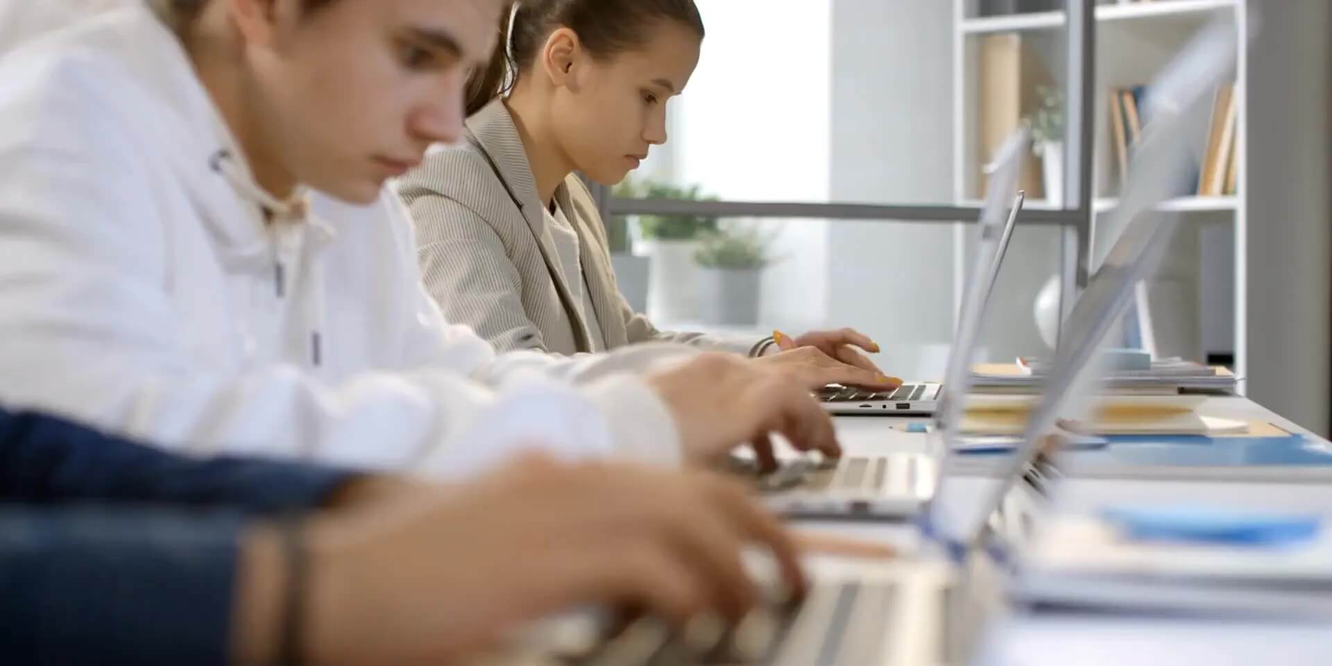 a row of students working on laptops